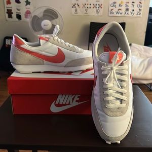Women’s white/orange Nike size 10.